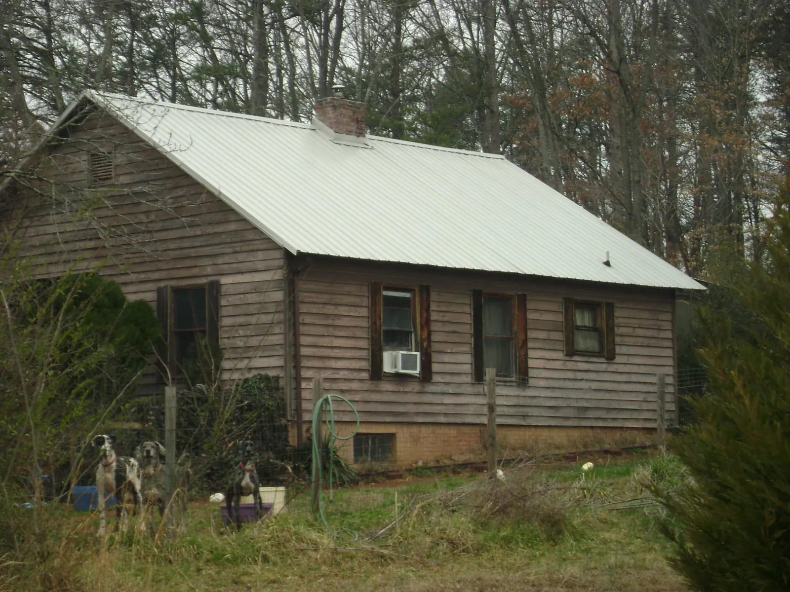 White metal roof on an old wood sided farmhouse, from a Metal Roof Installation job in Renfrew